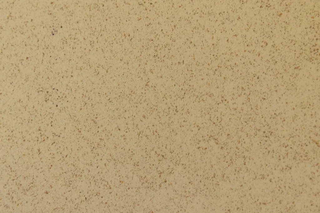 Official Comcork ivory colour close-up, speckled cork and rubber texture.